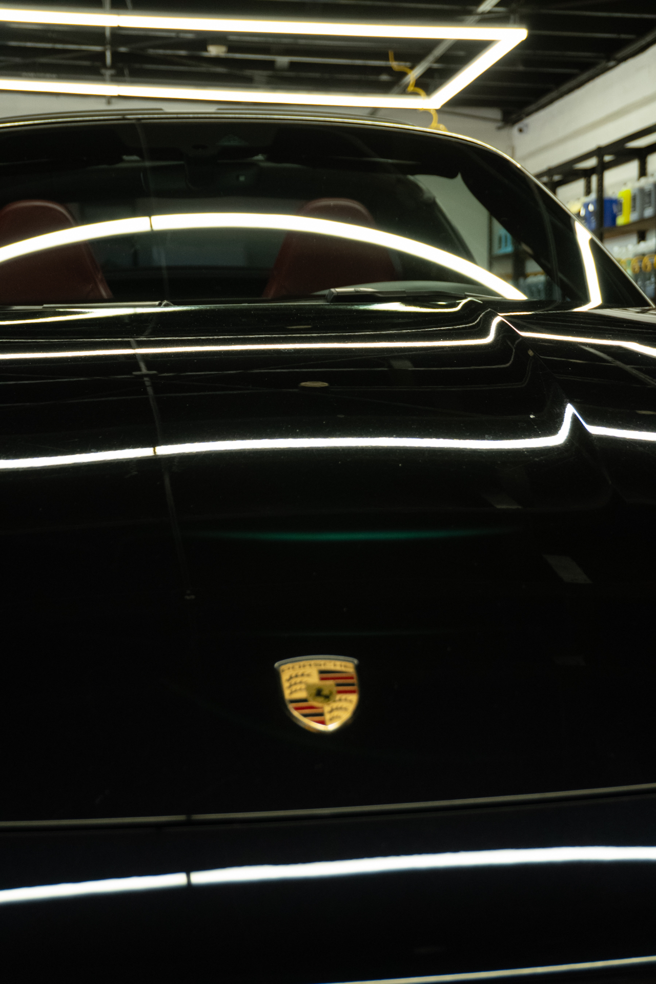 Porsche 911 Targa rear deck reflecting studio lighting after ceramic coating