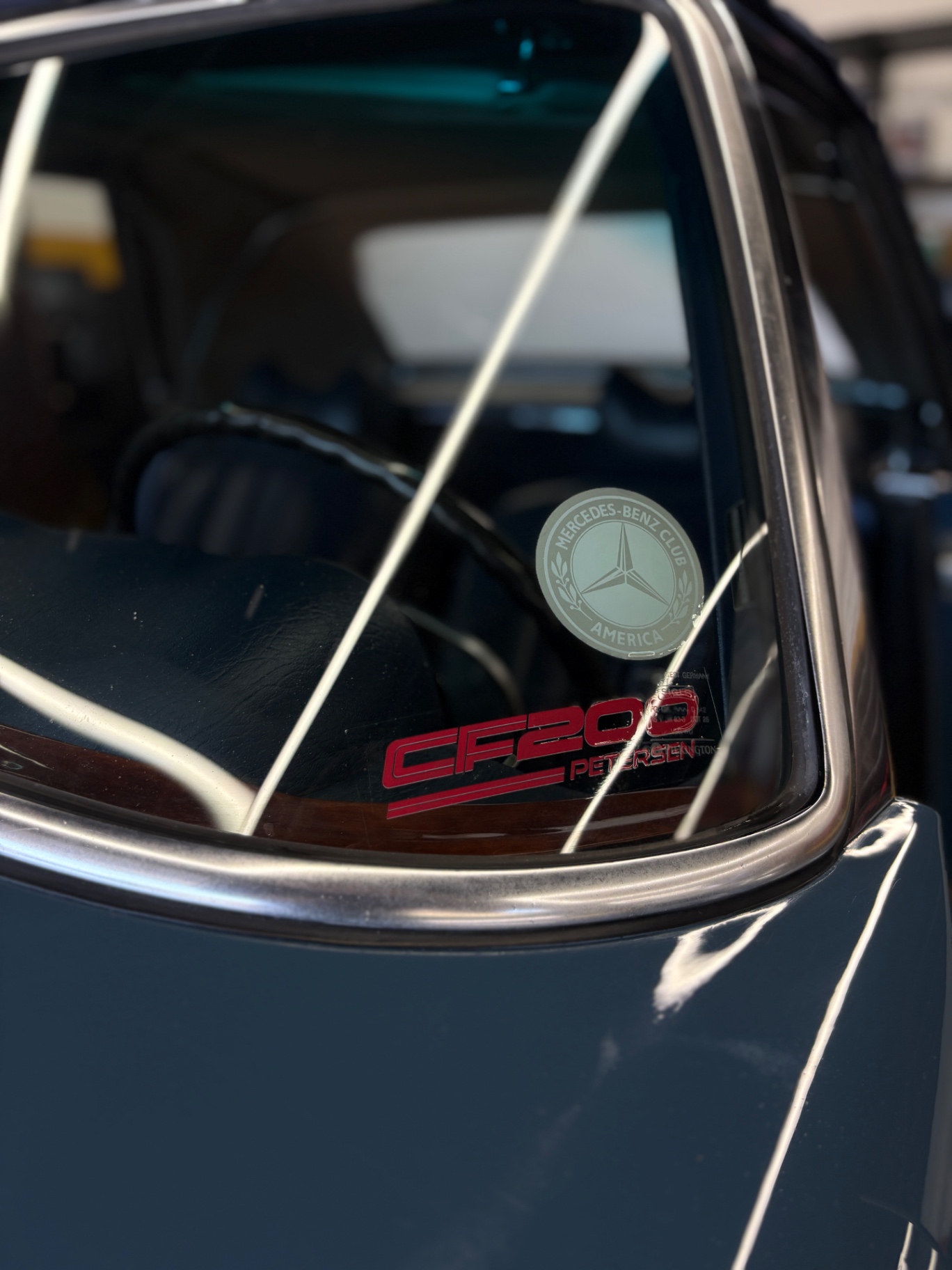 Mercedes-Benz 280SL rear quarter glass with Mercedes-Benz Club of America decal after detailing