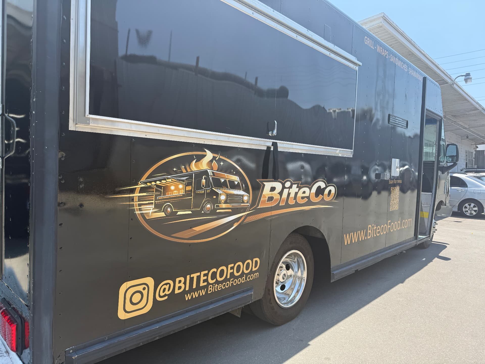 Close-up of the BiteCo logo graphic and Instagram handle on the truck