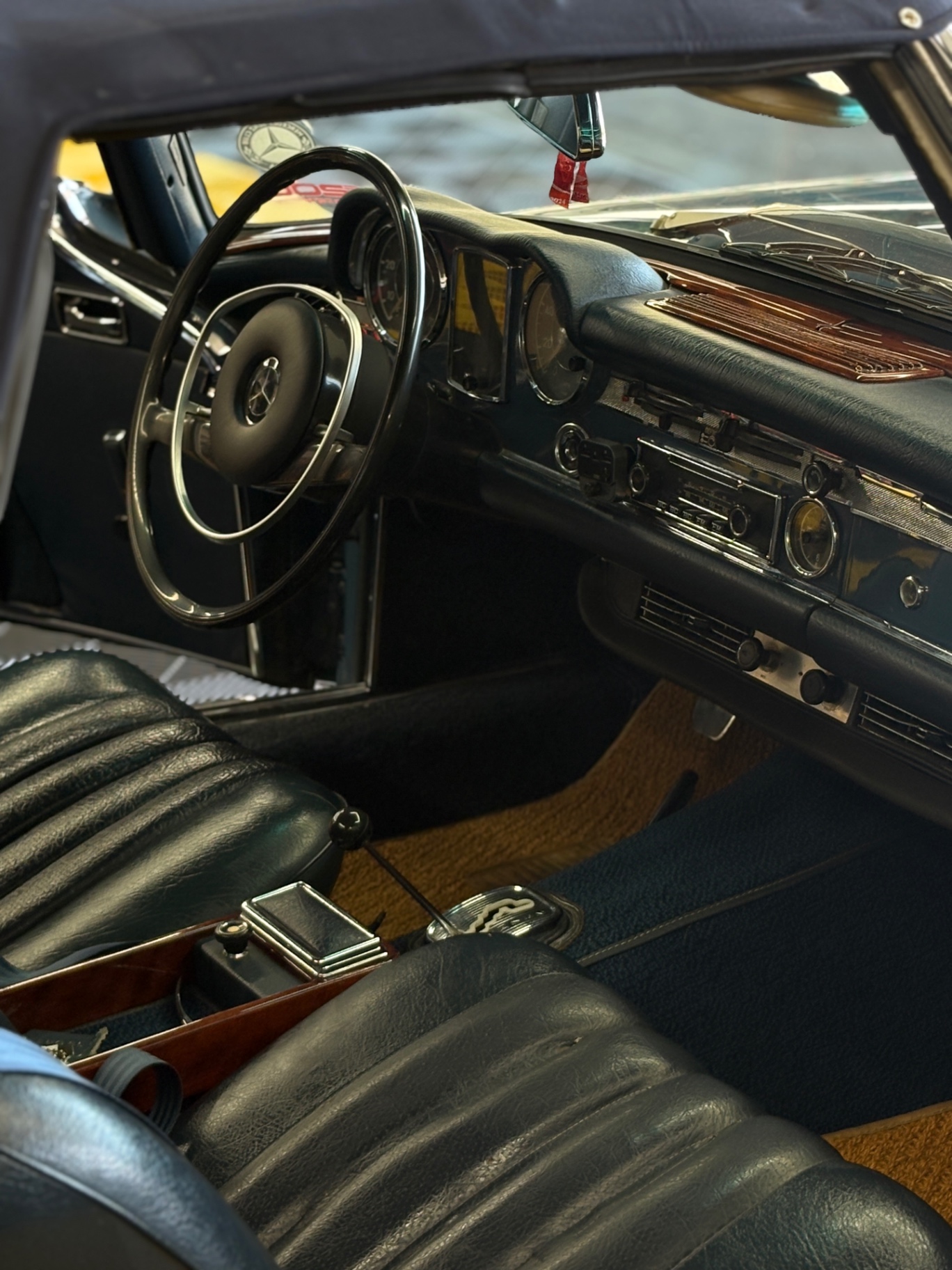Mercedes-Benz 280SL classic interior with black leather seats and wood trim after interior detail