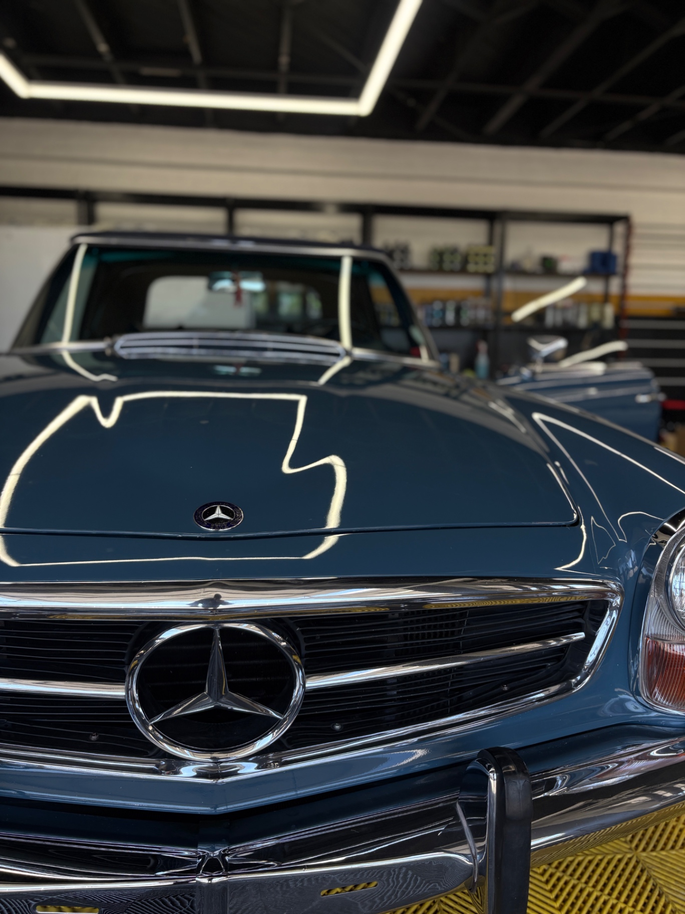 Mercedes-Benz 280SL chrome grille and hood with mirror-gloss paint after paint correction